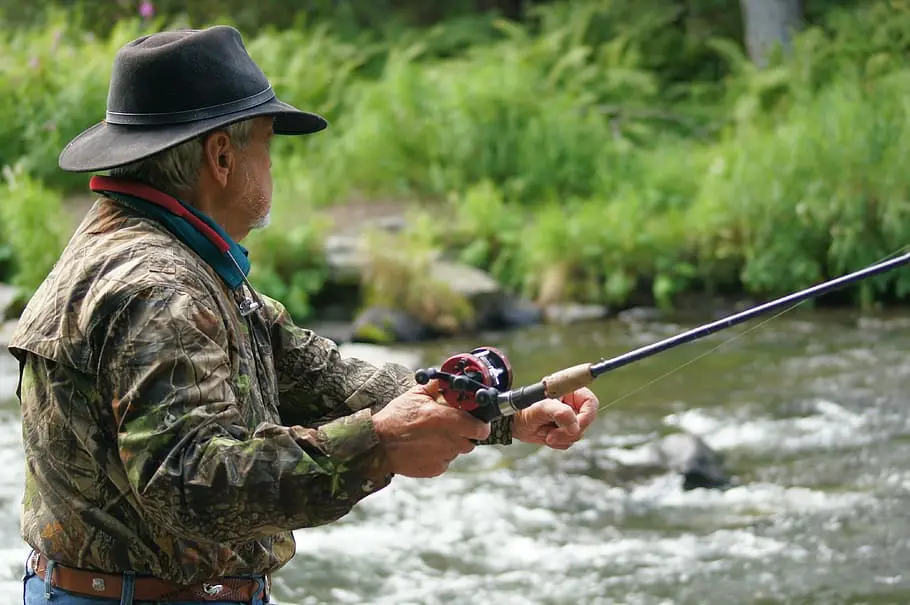 An avid fisherman fishing in the river. 