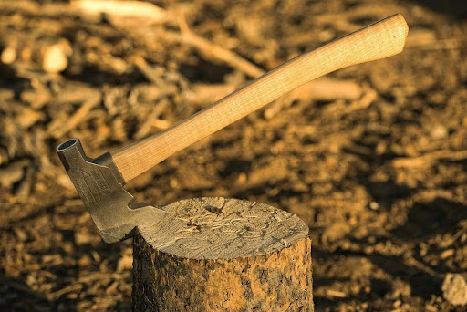 an axe stuck in a log