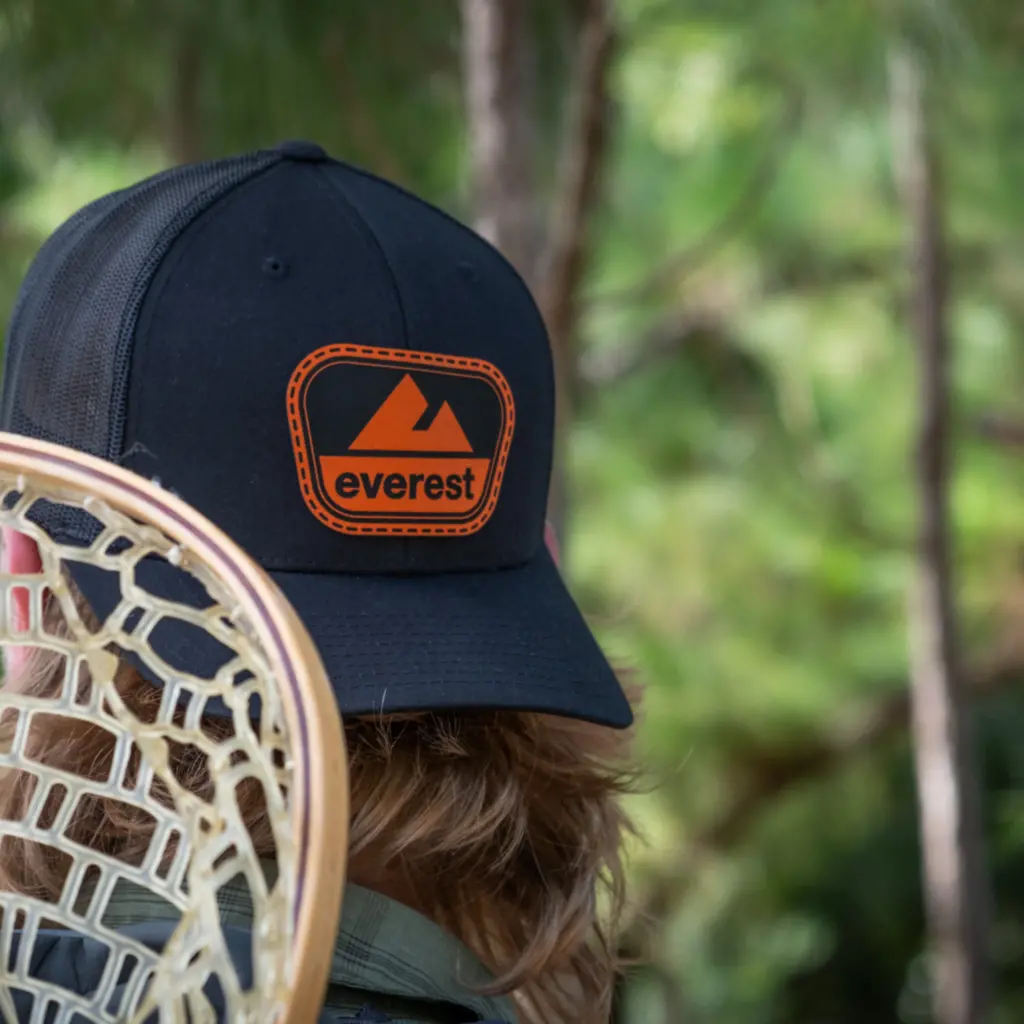 Guy getting ready to go fly fishing wearing the Everest 'National Park' Patch Hat on backwards. 